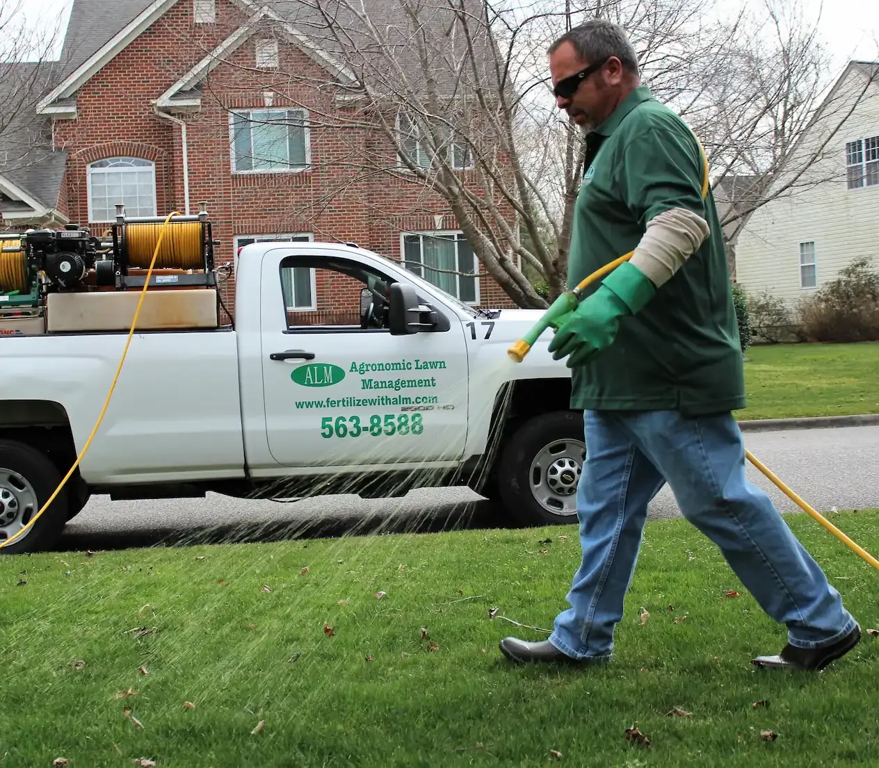 ALM team fertilizing lawn
